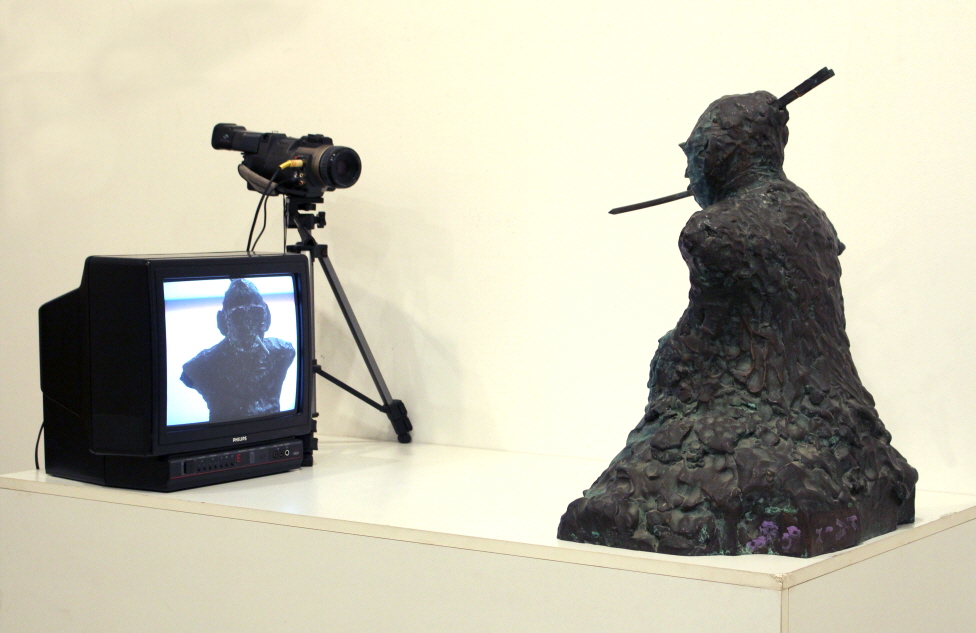 Nam June PAIK, TV Buddha, 1974/89, Bronze sculpture, TV monitor, closed-circuit camera, 70x140x105cm