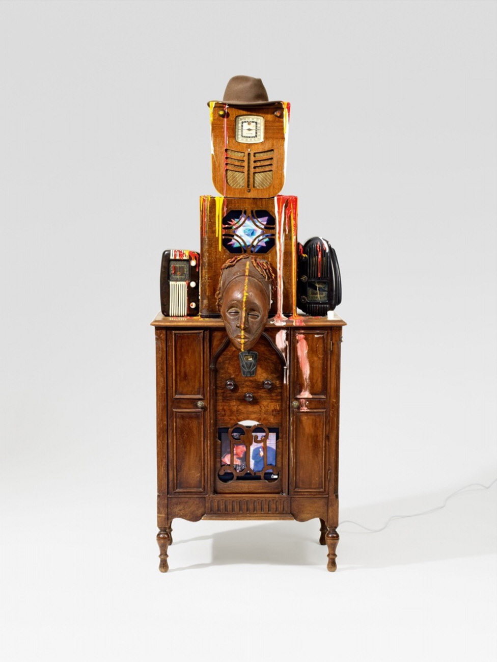 Nam June PAIK, Robot (Radio Man, Joseph Beuys), 1987, 2 vintage radio cabinets, 3 radios, 2 plasma monitors with built-in DVD players, African wooden mask, felt hat, acrylic, 2 DVDs, 194x75x55cm